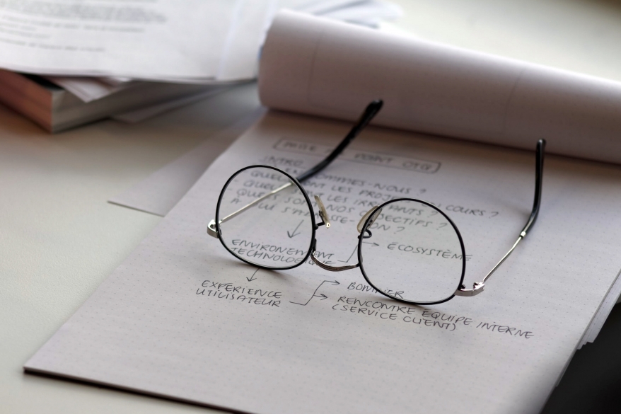 Glasses on the paper notebook - concept of education